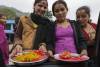 Girls offer a tika (red dot) for money. Prithvi Highway, Nepal